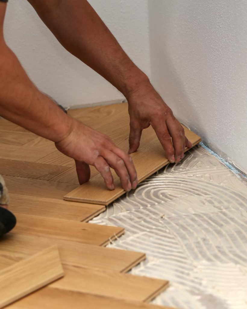 man laying wood parquet